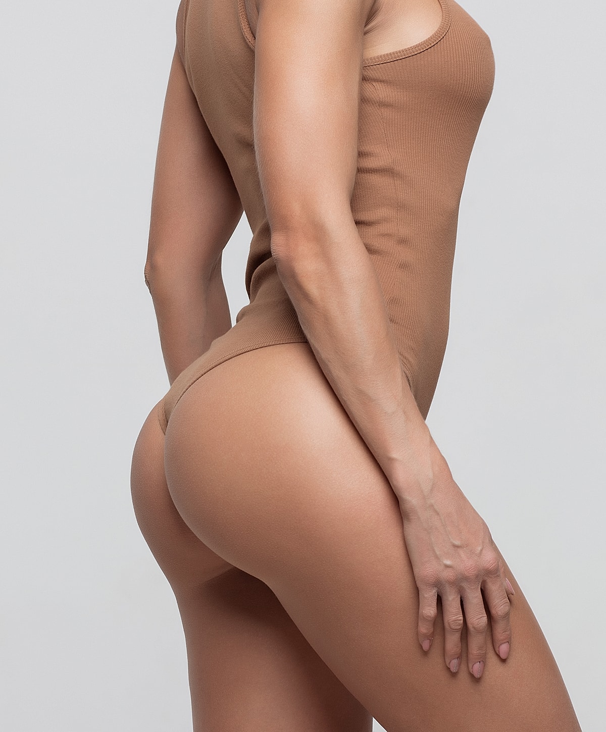 Model posing in a casual white outfit.