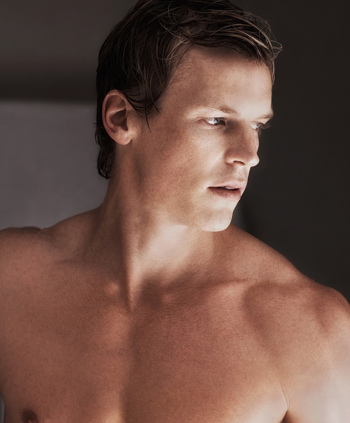 Model in brown swimwear posing confidently.