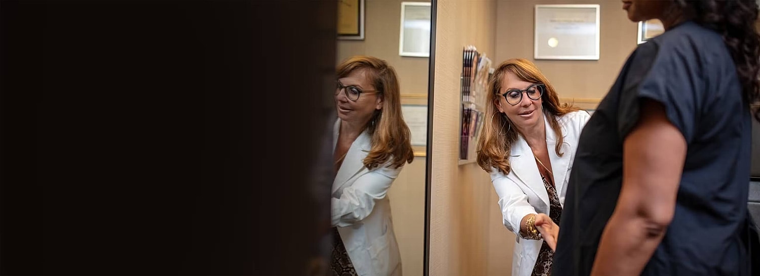 Doctor consulting with patient in office setting.