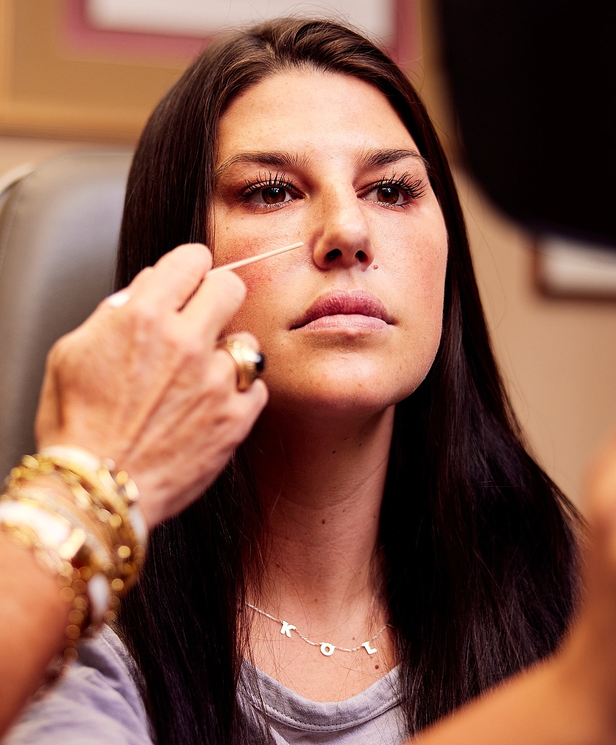 Model posing in a casual white outfit.