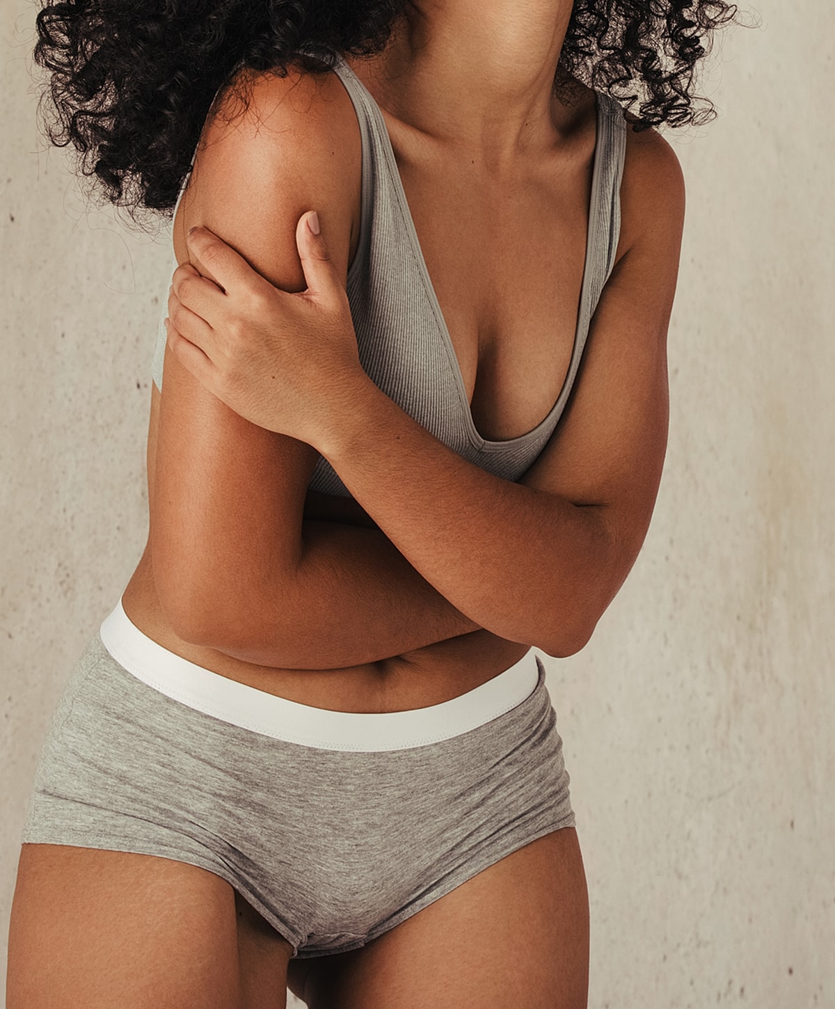 Model posing in a casual white outfit.