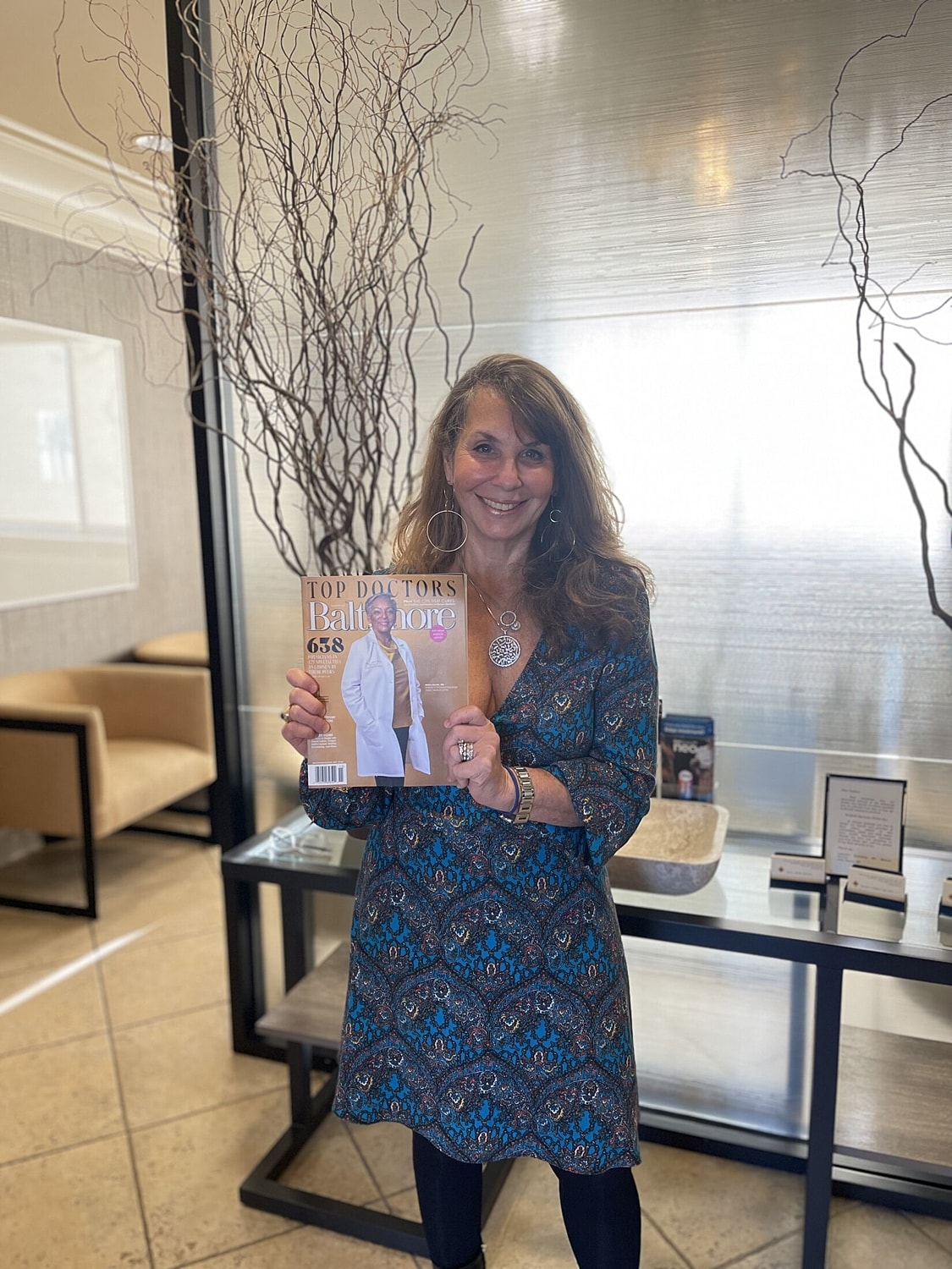 Yellow flowers and congratulatory card on desk.