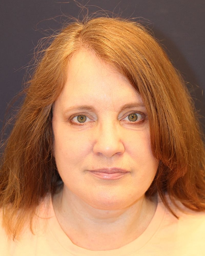 Woman with long brown hair and green eyes.