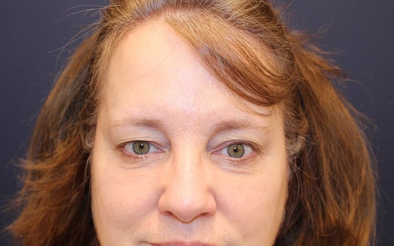 Woman with medium-length hair and green eyes.