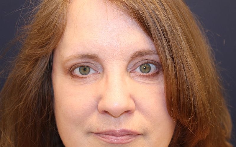 Close-up portrait of a woman with brown hair.