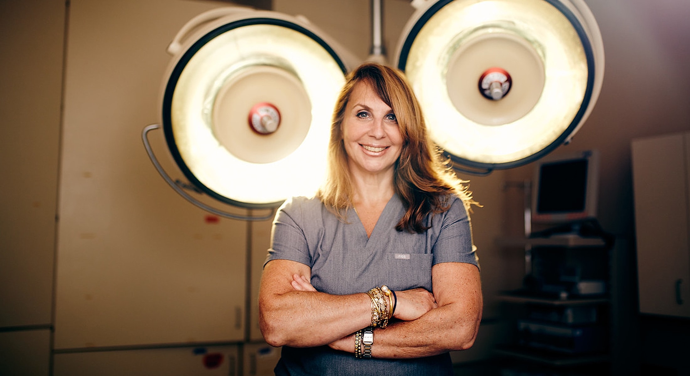 Smiling medical professional in surgical environment.