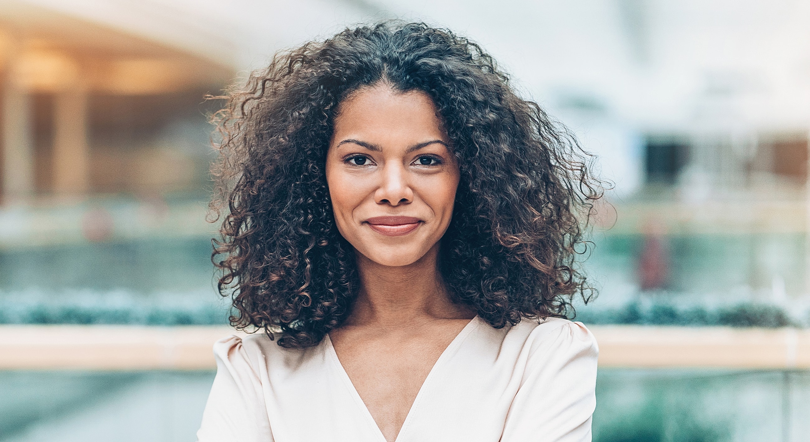 Woman with blonde hair wearing elegant jewelry.