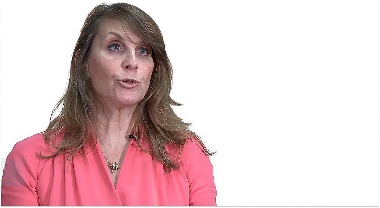 Woman speaking in an office setting.